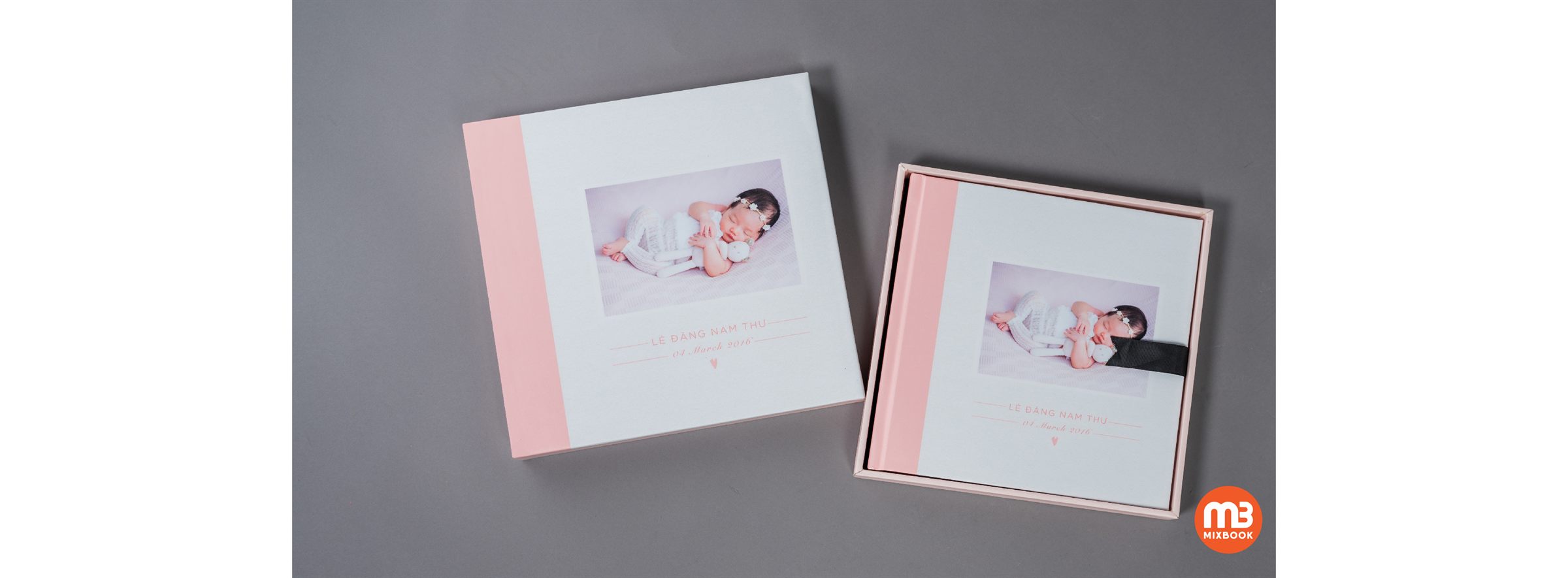 Photobook mở phẳng liền trang bìa hình, đặt cạnh hộp nắp rời